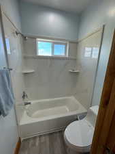 Second Full bathroom with wood finished floors, bathtub / shower combination, and toilet