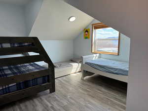 Bedroom featuring vaulted ceiling and wood finished floors