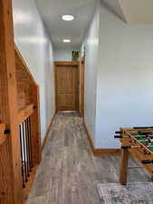 Hall featuring wood finished floors and baseboards