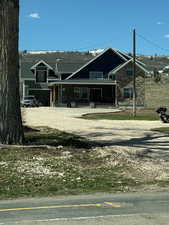 View of front of home featuring stone siding and covered porch