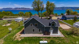 Birds eye view of property with a water and mountain view