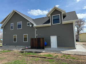 Rear view of house with roof with shingles