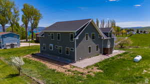 Rear view of property with a yard and a mountain view