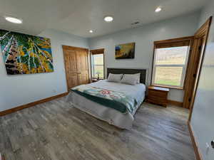 Primary Bedroom featuring baseboards, and wood finished floors