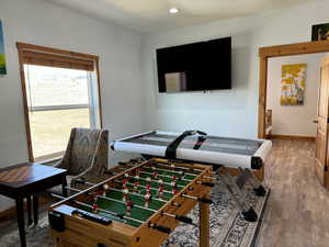 Playroom featuring recessed lighting, a textured ceiling, baseboards, and wood finished floors