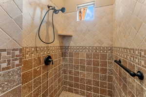 Bathroom featuring tiled shower