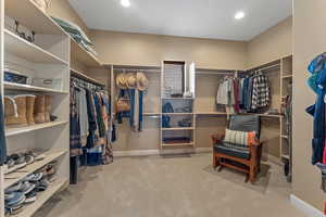 Walk in closet featuring light carpet