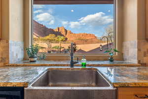 Details featuring tasteful backsplash, a mountain view, and a sink