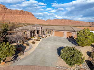 Mediterranean / spanish-style house with a garage, driveway, a tile roof, and a mountain view