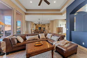 Living area with stone tile flooring, baseboards, a ceiling fan, and recessed lighting