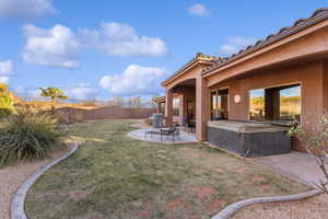 View of yard featuring a patio area, a fenced backyard, and a hot tub