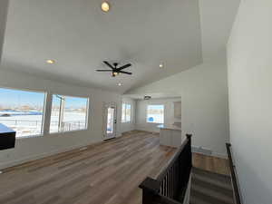 Foyer entrance with lofted ceiling, recessed lighting, visible vents, light wood-style floors, and a textured ceiling