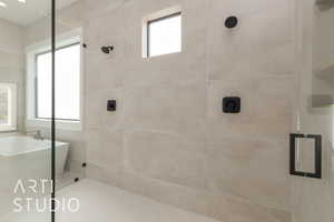 Full bathroom featuring a freestanding bath and a tile shower