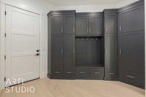 Mudroom featuring light wood finished floors