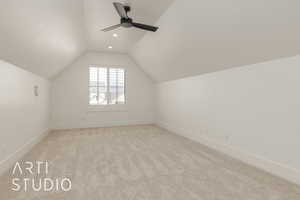 Bonus room featuring visible vents, a ceiling fan, light carpet, vaulted ceiling, and baseboards