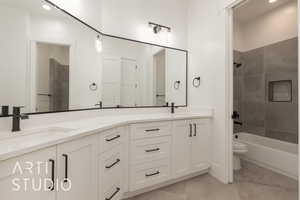 Bathroom with washtub / shower combination, tile patterned flooring, a sink, and double vanity