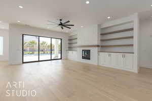 Unfurnished living room with built in shelves, light wood finished floors, recessed lighting, visible vents, and a stone fireplace