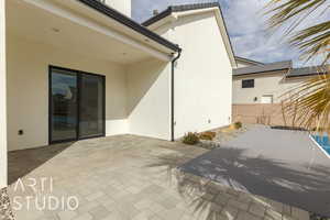 View of patio featuring fence