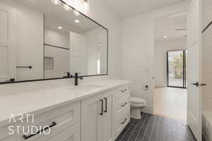 Bathroom featuring a shower, vanity, toilet, and recessed lighting