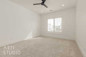 Empty room featuring light carpet, visible vents, baseboards, ceiling fan, and recessed lighting