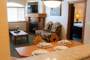 Living area with a textured wall and a fireplace with flush hearth
