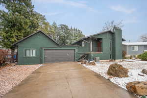 View of exterior with newer stucco and an attached garage