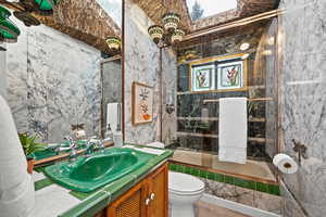 Full bathroom with toilet, combined bath / shower with glass door, and vanity