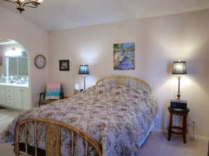 Bedroom featuring ensuite bath and carpet floors