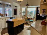 Kitchen with light tile patterned floors and decorative light fixtures