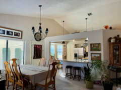 Dining space featuring carpet floors and lofted ceiling