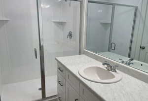 Bathroom with a shower stall and vanity