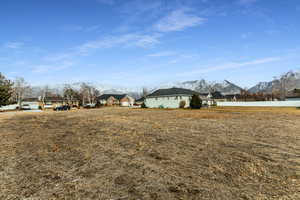 View of yard featuring a residential view, a mountain view, and fence