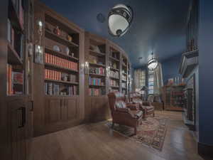 Cozy Library with fireplace and access to a private office.