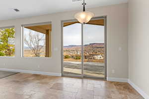 Entryway with baseboards, visible vents, a mountain view, and stone tile flooring