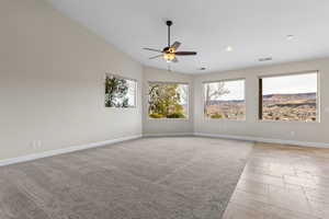 Spare room with ceiling fan, lofted ceiling, recessed lighting, visible vents, and baseboards