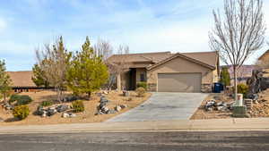 View of front of home with stucco siding, concrete driveway, a garage, stone siding, and a tiled roof