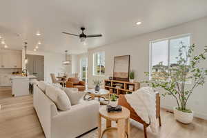 Living room with light wood-type flooring, plenty of natural light, and recessed lighting