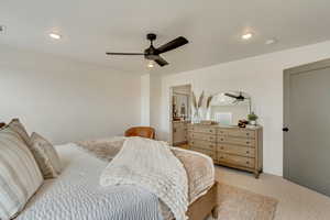 Bedroom with a ceiling fan, visible vents, recessed lighting, and light colored carpet