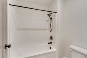Full bathroom featuring shower / bathtub combination and toilet