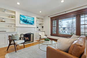 Tiled gas fireplace with custom built-in shelving