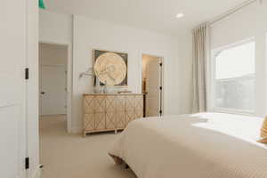 Bedroom with recessed lighting and light colored carpet