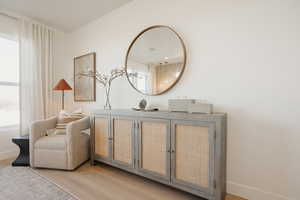 Living area with light wood-type flooring and baseboards