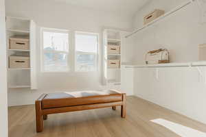 Living area with light wood finished floors and baseboards