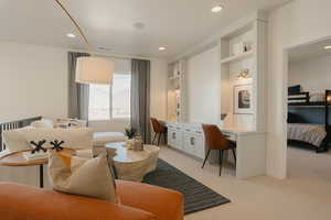 Interior space featuring light carpet, recessed lighting, and built in study area