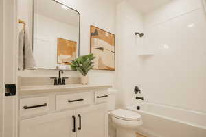 Full bathroom featuring  shower combination, vanity, and toilet