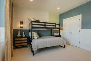 Bedroom with recessed lighting, a closet, and light colored carpet