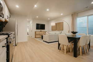 Dining room with recessed lighting, baseboards, visible vents, and light wood finished floors