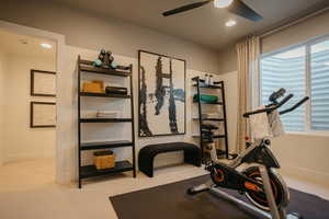 Exercise area with a ceiling fan, recessed lighting, light carpet, and baseboards