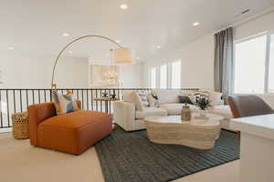 Carpeted living area featuring visible vents, a chandelier, and recessed lighting