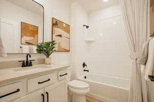 Full bath with vanity, bathtub / shower combination, and toilet